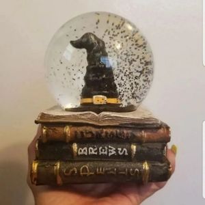 Halloween witch hat bookstack snow globe